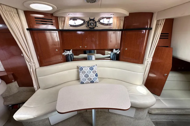 Slide: The Image of Luxurious interior of 2003 Sea Ray 320 Sundancer with elegant seating and wooden cabinetry. - 44