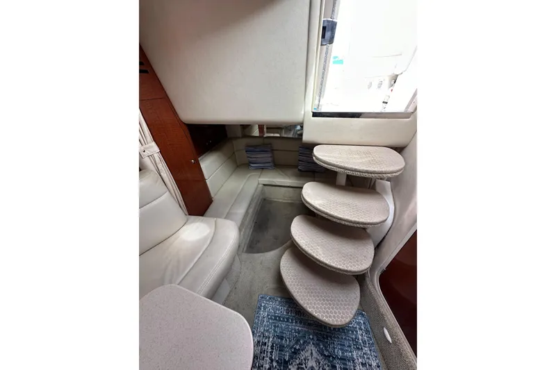 Slide: The Image of Interior of 2003 Sea Ray 320 Sundancer with curved steps and seating area. - 45
