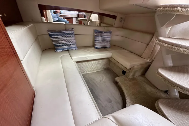 Slide: The Image of Luxurious interior of 2003 Sea Ray 320 Sundancer with plush seating and striped cushions. - 46