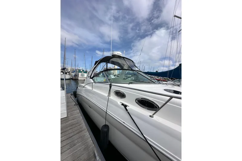 Slide: The Image of 2003 Sea Ray 320 Sundancer yacht docked at marina under blue sky. - 5