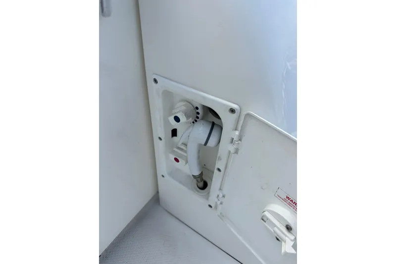 Slide: The Image of 2003 Sea Ray 320 Sundancer boat shower control panel with hot and cold settings. - 52