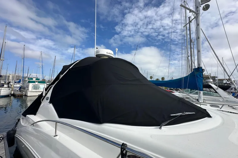 Slide: The Image of 2003 Sea Ray 320 Sundancer yacht docked at marina under blue sky. - 54