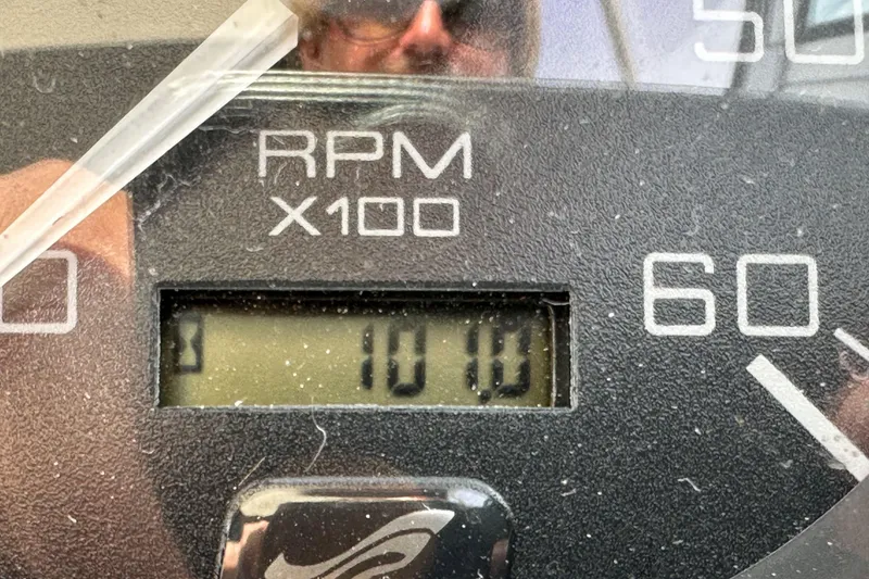 Slide: The Image of Close-up of a 2003 Sea Ray 320 Sundancer RPM gauge displaying 1010 RPM. - 56