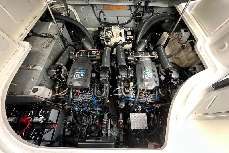 Slide: The Image of Engine compartment of a 2003 Sea Ray 320 Sundancer boat, showcasing dual engines. - 61