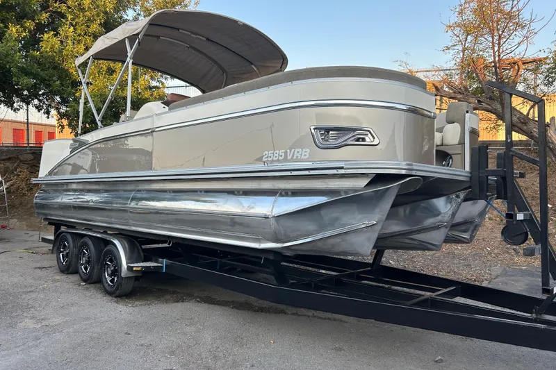 The Image of 2022 Avalon Catalina 2585 VRB pontoon boat on trailer by the water. - 0