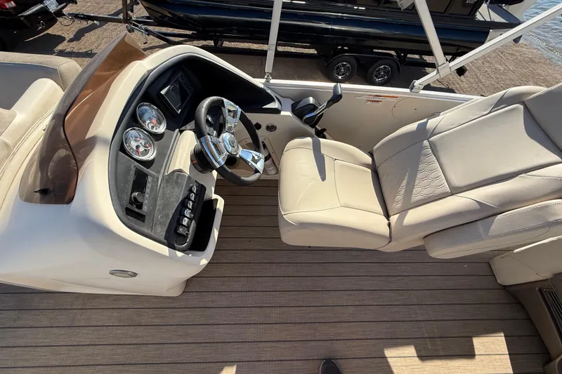 Slide: The Image of 2022 Avalon Catalina 2585 VRB boat dashboard with steering wheel and controls. - 100