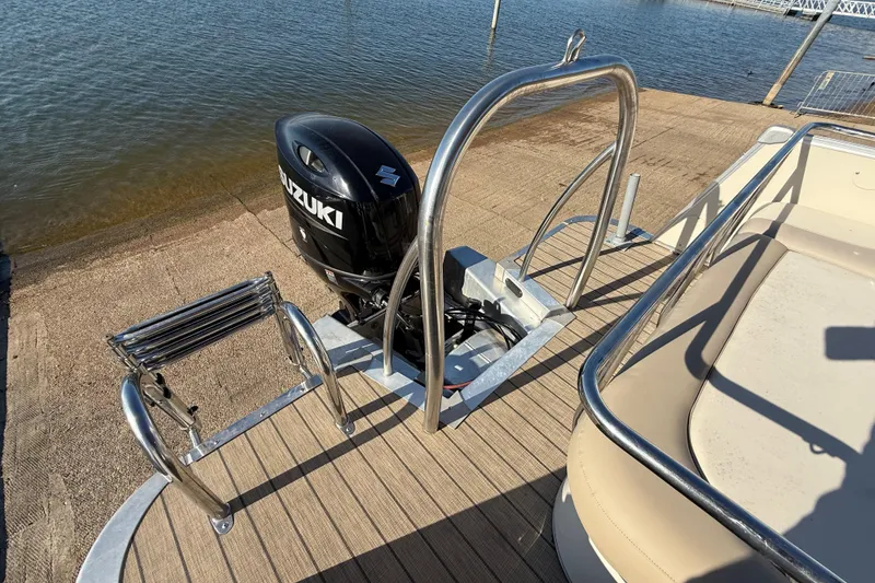 Slide: The Image of 2022 Avalon Catalina 2585 VRB boat interior with beige seating and steering wheel. - 102