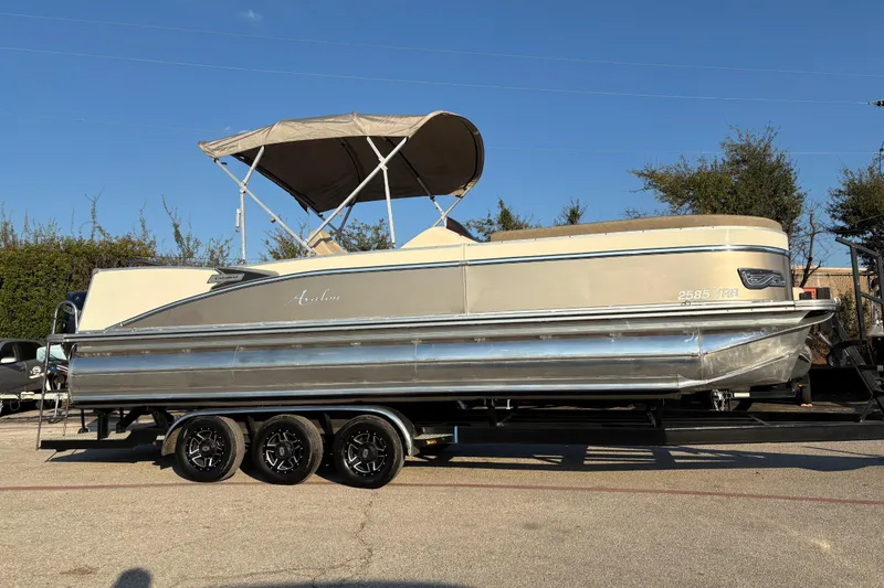 Slide: The Image of 2022 Avalon Catalina 2585 VRB pontoon boat on trailer under clear blue sky. - 14