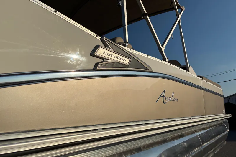 Slide: The Image of 2022 Avalon Catalina 2585 VRB pontoon boat on trailer, featuring a beige canopy. - 17
