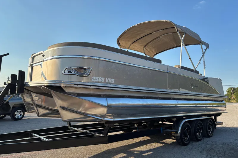 Slide: The Image of 2022 Avalon Catalina 2585 VRB pontoon boat on a trailer, under a clear blue sky. - 29