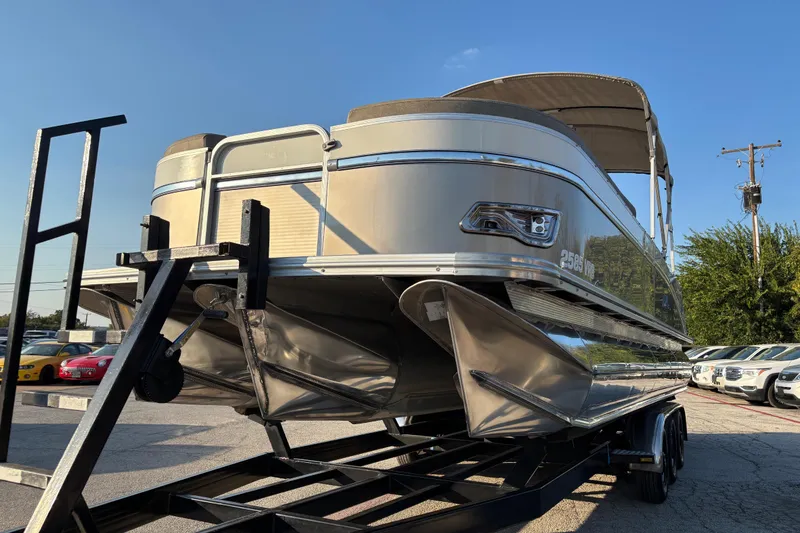 Slide: The Image of 2022 Avalon Catalina 2585 VRB pontoon boat on trailer, sunny day, parking lot background. - 30