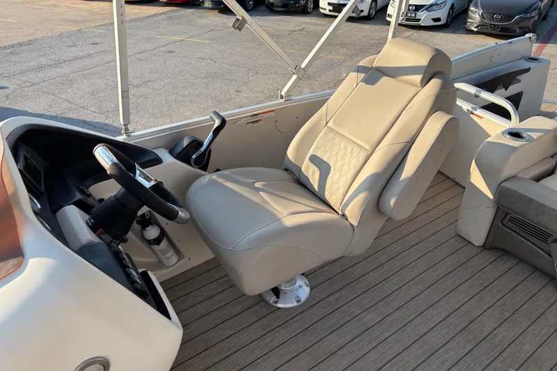 Slide: The Image of 2022 Avalon Catalina 2585 VRB boat interior with beige captain's chair and steering wheel. - 37