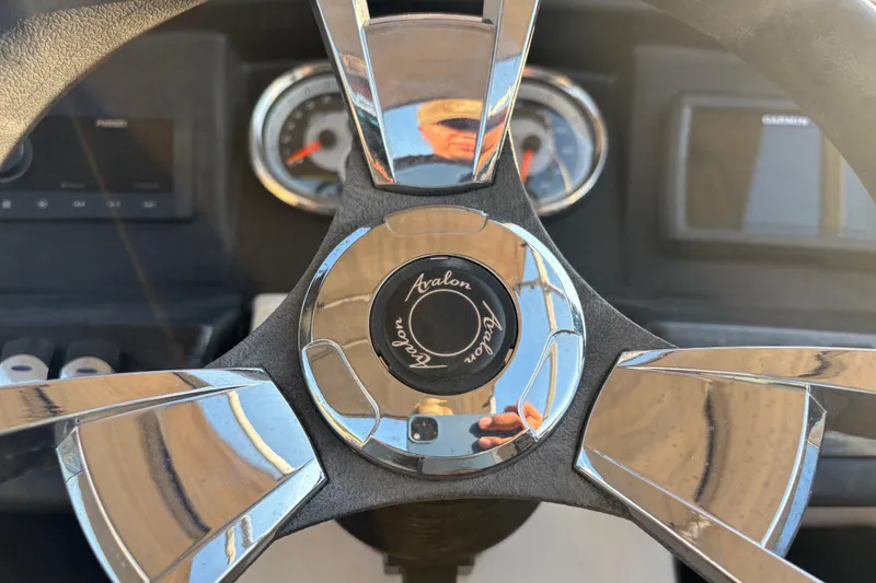 Slide: The Image of Steering wheel of 2022 Avalon Catalina 2585 VRB boat, featuring chrome accents and dashboard instruments. - 47