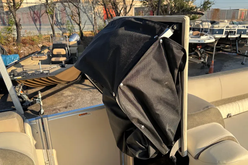 Slide: The Image of 2022 Avalon Catalina 2585 VRB boat interior with black cover and beige seating. - 58