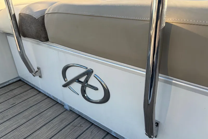 Slide: The Image of 2022 Avalon Catalina 2585 VRB boat interior with logo and cushioned seating. - 65