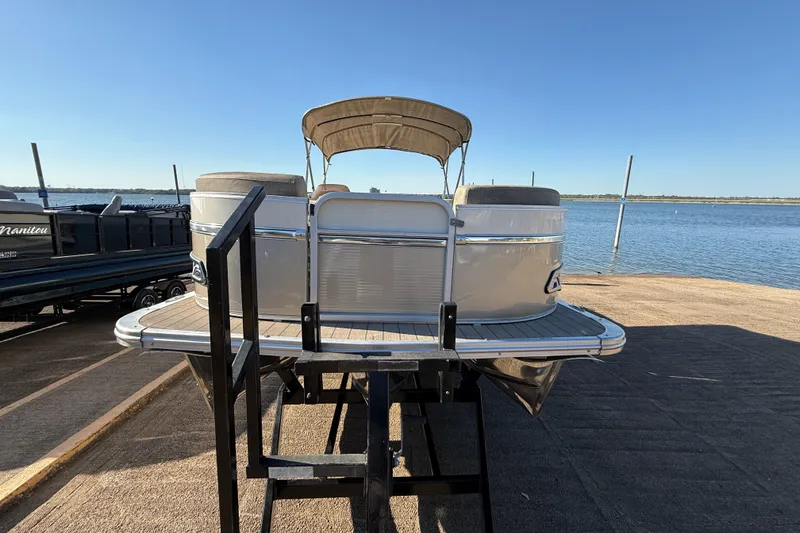 Slide: The Image of 2022 Avalon Catalina 2585 VRB pontoon boat on trailer by the water. - 68