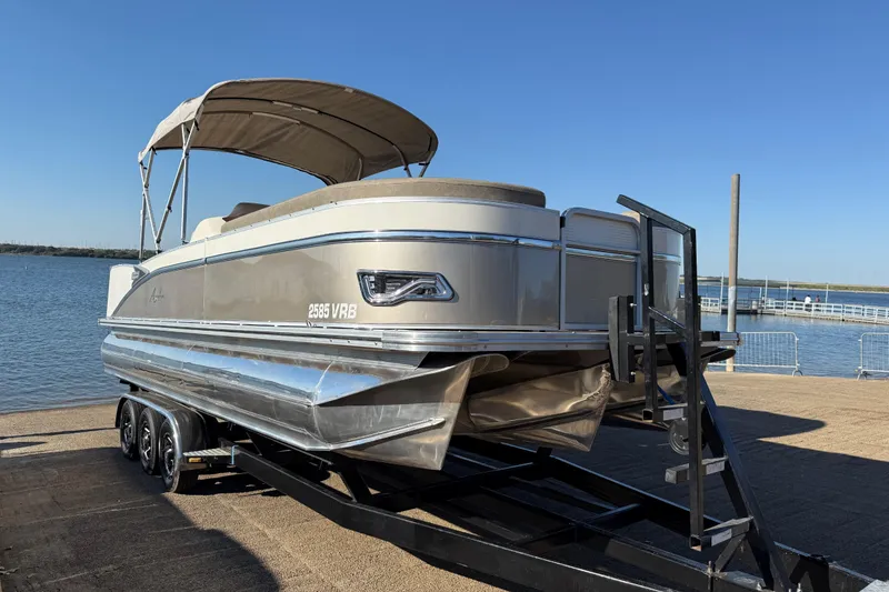 Slide: The Image of 2022 Avalon Catalina 2585 VRB pontoon boat on a dock by the water. - 69