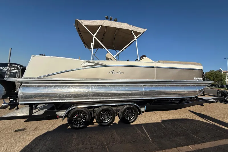 Slide: The Image of 2022 Avalon Catalina 2585 VRB pontoon boat on trailer under clear blue sky. - 73