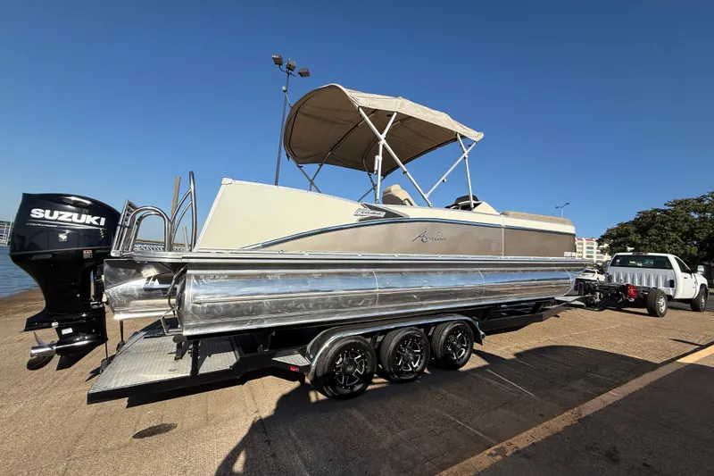 Slide: The Image of 2022 Avalon Catalina 2585 VRB pontoon boat on trailer under clear blue sky. - 74