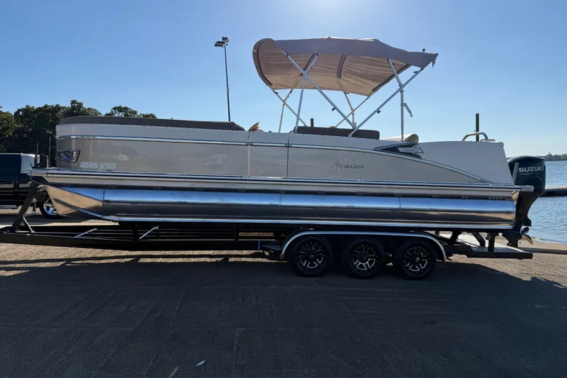 Slide: The Image of 2022 Avalon Catalina 2585 VRB pontoon boat on trailer by waterfront. - 89
