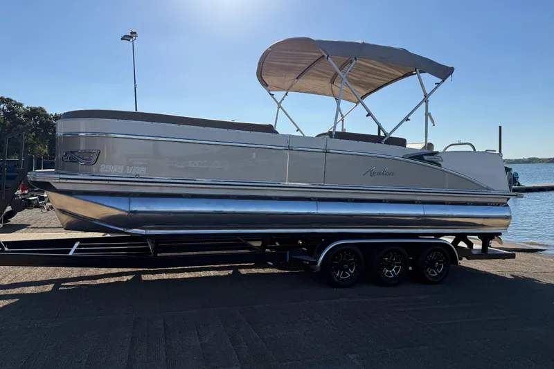 Slide: The Image of 2022 Avalon Catalina 2585 VRB pontoon boat on trailer, dockside view. - 90