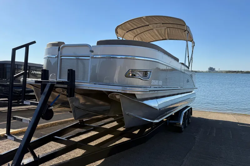 Slide: The Image of 2022 Avalon Catalina 2585 VRB pontoon boat on trailer by the water. - 93