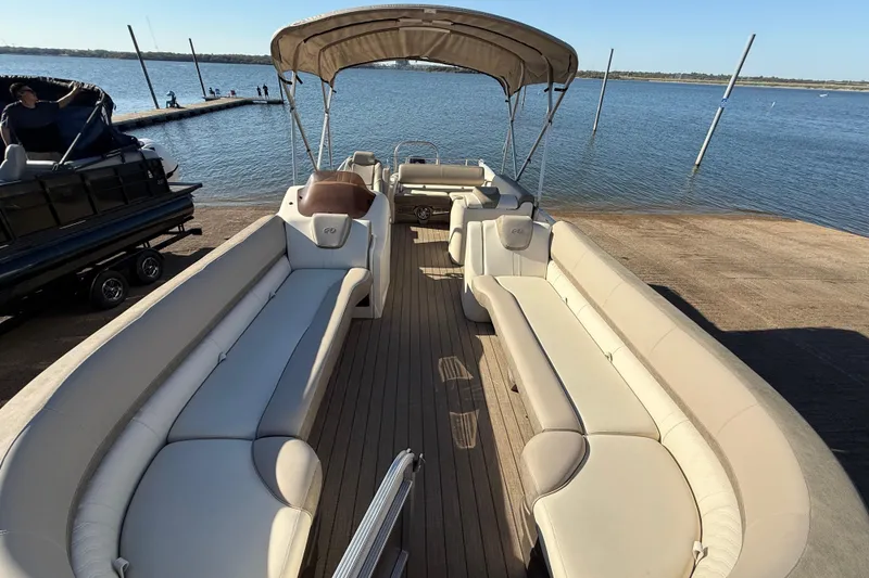 Slide: The Image of 2022 Avalon Catalina 2585 VRB pontoon boat on trailer by the water. - 94