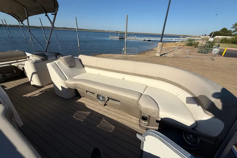 Slide: The Image of Luxurious seating on 2022 Avalon Catalina 2585 VRB pontoon boat, docked near trucks. - 96