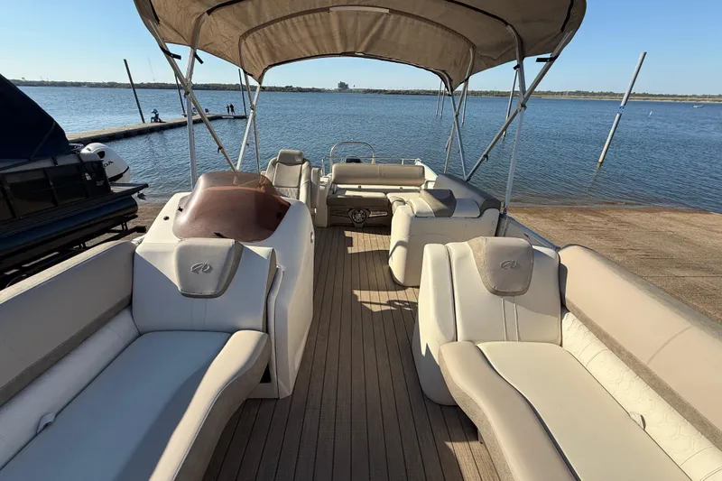 Slide: The Image of 2022 Avalon Catalina 2585 VRB boat interior with spacious seating and lake view. - 97