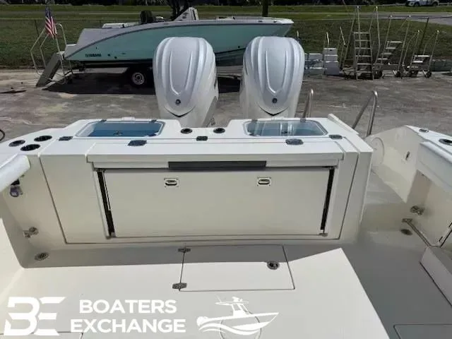 Slide: The Image of 2026 Cobia 320 Center Console with dual outboard engines. - 3