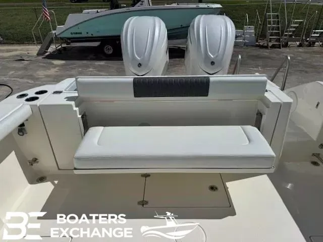 Slide: The Image of 2026 Cobia 320 Center Console with dual engines and bench seating. - 4