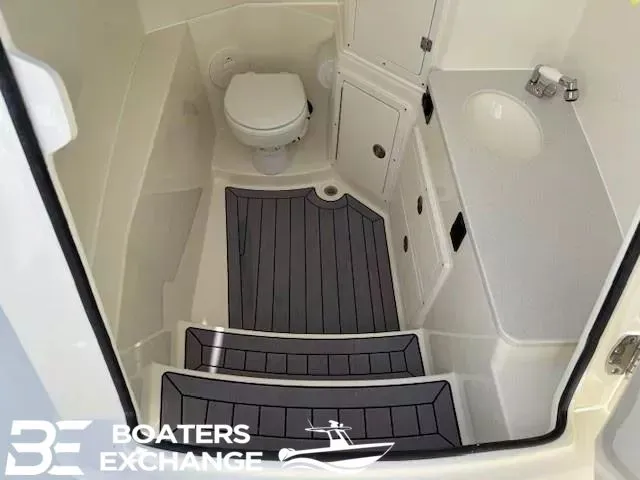 Slide: The Image of Interior of 2026 Cobia 320 Center Console with toilet and sink. - 8