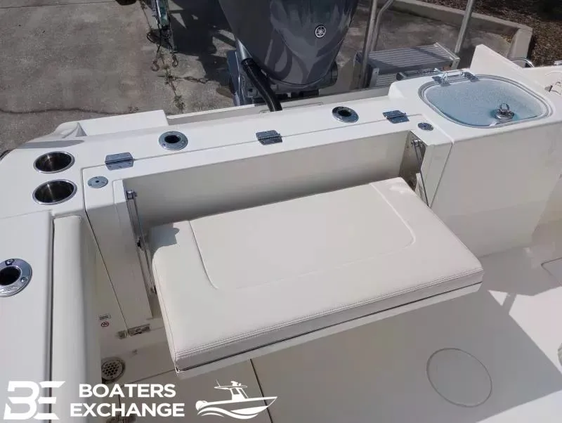 Slide: The Image of 2022 Cobia 240 Center Console with bench seat and rod holders. - 4