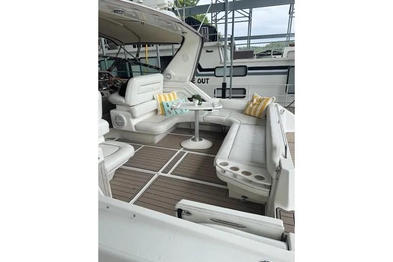 Slide: The Image of 1998 Sea Ray 400 Express Cruiser interior with white seating and striped cushions. - 15