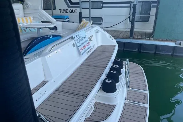 Slide: The Image of 1998 Sea Ray 400 Express Cruiser docked, featuring spacious deck and seating area. - 16