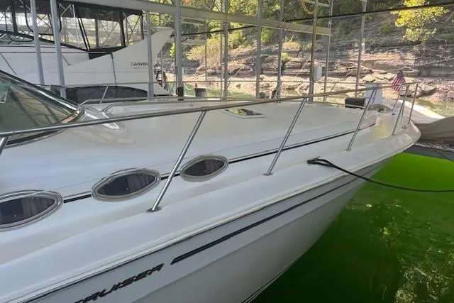 Slide: The Image of 1998 Sea Ray 400 Express Cruiser docked, showcasing sleek design and spacious deck. - 3