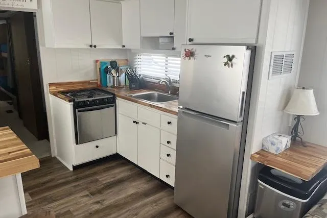 Slide: The Image of 1985 Jamestowner 16 x 63 houseboat kitchen with modern appliances and wood countertops. - 12