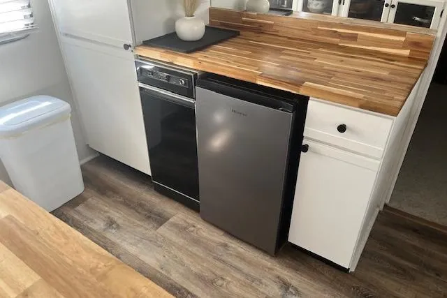 Slide: The Image of Kitchen area of a 1985 Jamestowner 16 x 63 houseboat with modern appliances. - 13