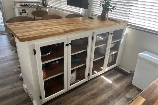 Slide: The Image of 1985 Jamestowner houseboat kitchen with wooden countertop and glass cabinet doors. - 15