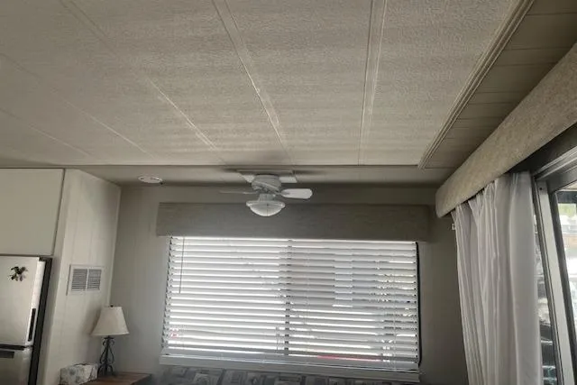 Slide: The Image of Interior of 1985 Jamestowner 16 x 63 houseboat with blinds, ceiling fan, and lamp. - 17