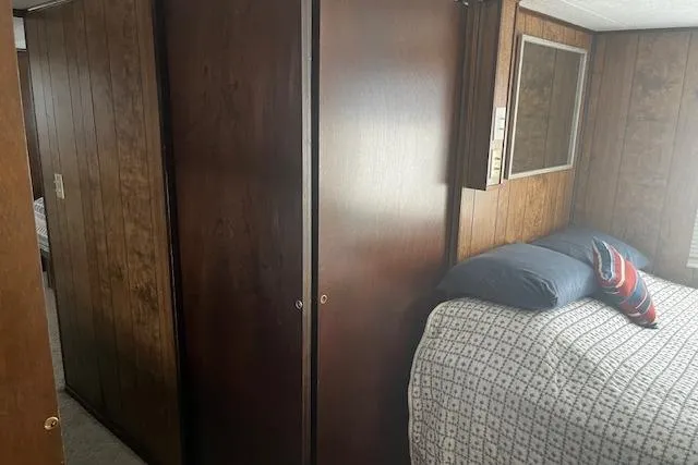 Slide: The Image of Interior of 1985 Jamestowner 16 x 63 houseboat bedroom with wood paneling and bed. - 18