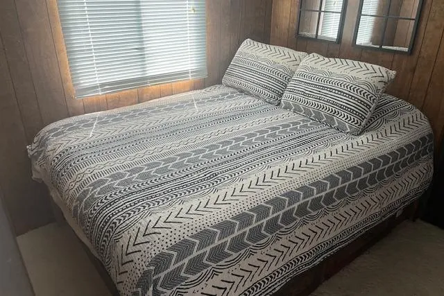 Slide: The Image of Cozy bedroom in 1985 Jamestowner houseboat with patterned bedding and wooden walls. - 29