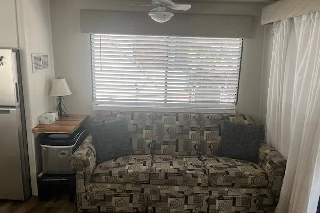 Slide: The Image of Cozy living area in 1985 Jamestowner 16 x 63 houseboat with patterned sofa and window blinds. - 31