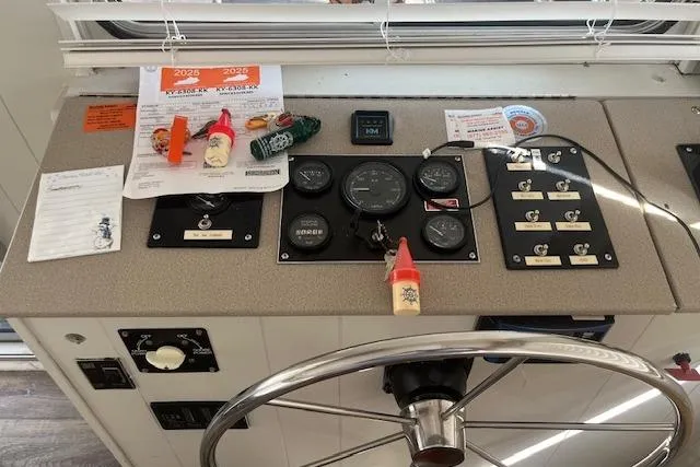 Slide: The Image of 1985 Jamestowner 16 x 63 Houseboat control panel with gauges and steering wheel. - 7