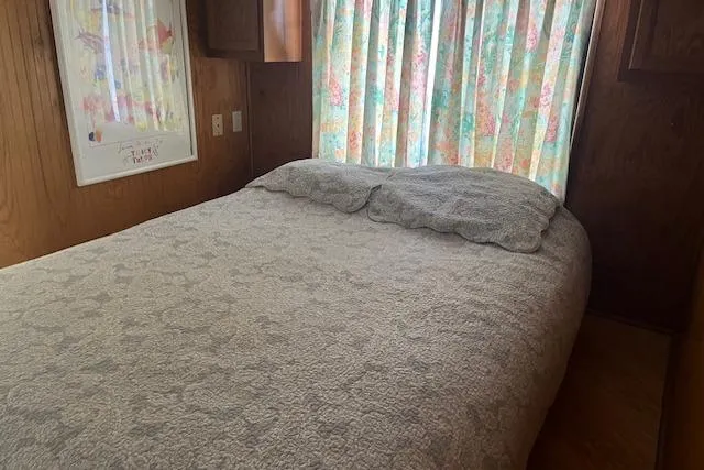 Slide: The Image of Cozy bedroom in 1992 Jamestowner 16x72 houseboat with floral curtains and quilted bedding. - 11