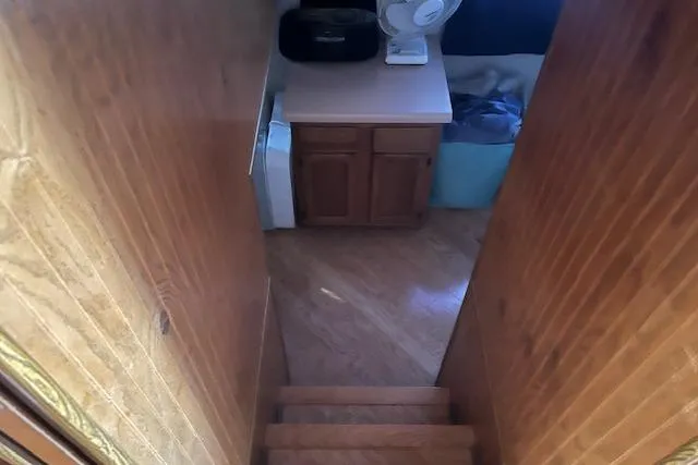 Slide: The Image of Interior view of 1992 Jamestowner 16x72 houseboat with wooden stairs and cabinet. - 12