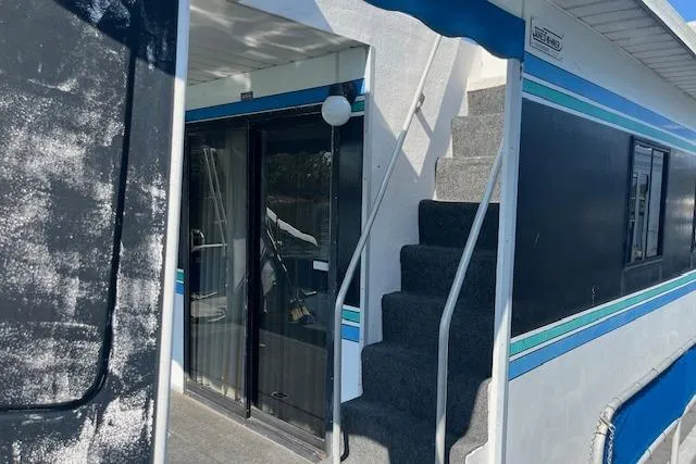 Slide: The Image of 1992 Jamestowner 16x72 houseboat with exterior stairs and sliding glass doors. - 19