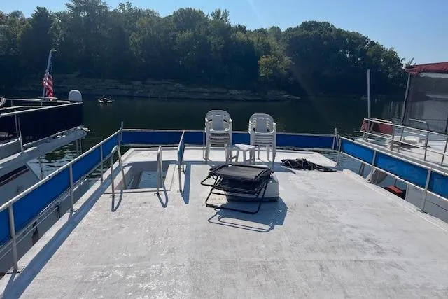 Slide: The Image of Rooftop deck of 1992 Jamestowner 16x72 houseboat with chairs, overlooking serene water and trees. - 21