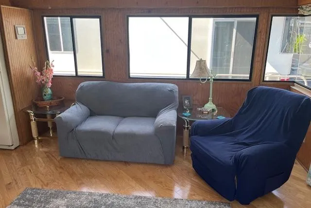 Slide: The Image of Interior of 1992 Jamestowner houseboat with cozy seating and wooden paneling. - 5