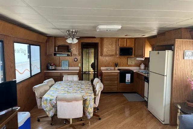 Slide: The Image of Interior of a 1992 Jamestowner 16x72 houseboat with kitchen and dining area. - 7